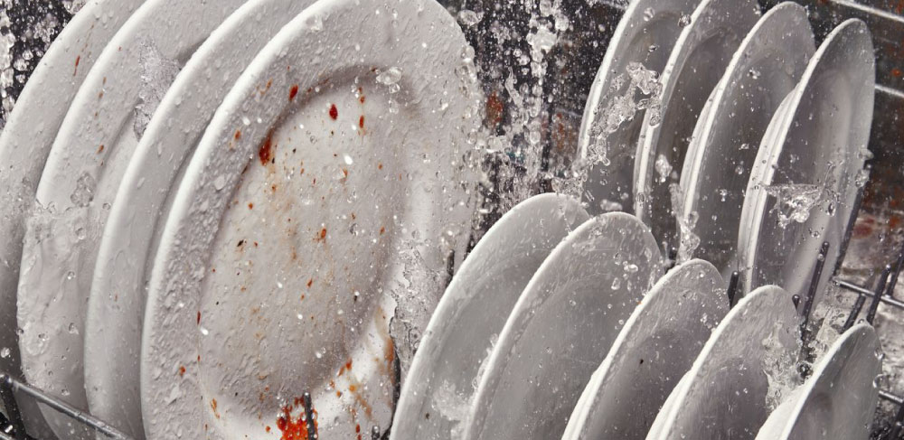 Water spraying dishes inside a dishwasher