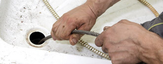 Plumber Inspecting Pipe